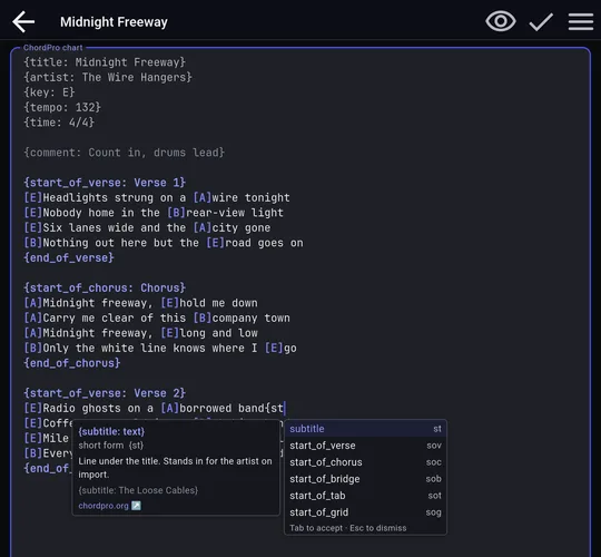 BandBinder's chart editor with the ChordPro directive autocomplete popup and inline help box open